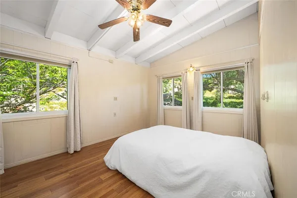 a bed sitting in a bedroom next to a window