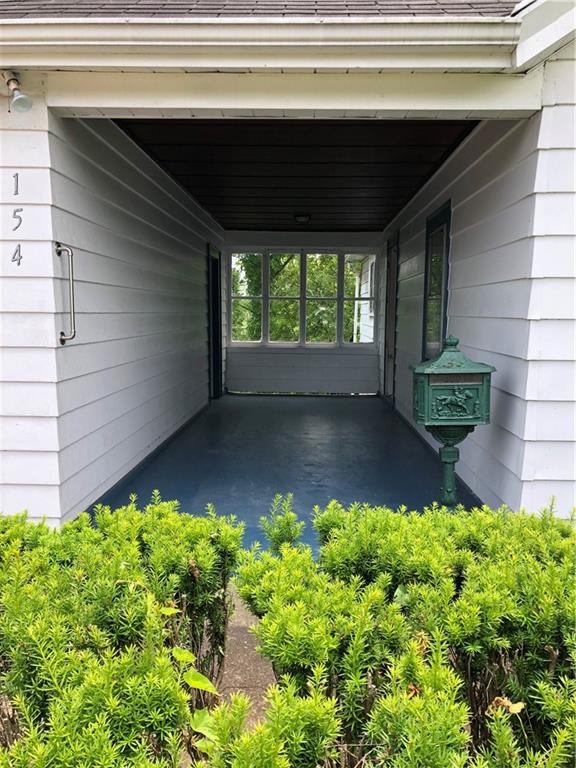 Covered and protected (from natural elements) breezeway between garages and side kitchen entry.