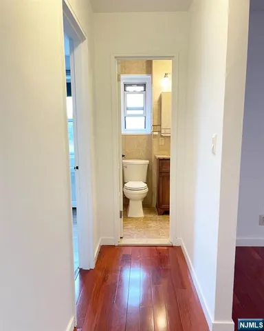 a view of a room with wooden floor