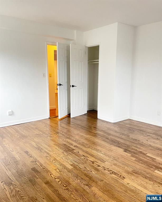 2205 North Central Road, Unit 3D Fort Lee, NJ 07024 - Photo 17 of 29 a view of empty room with wooden floor and bathroom