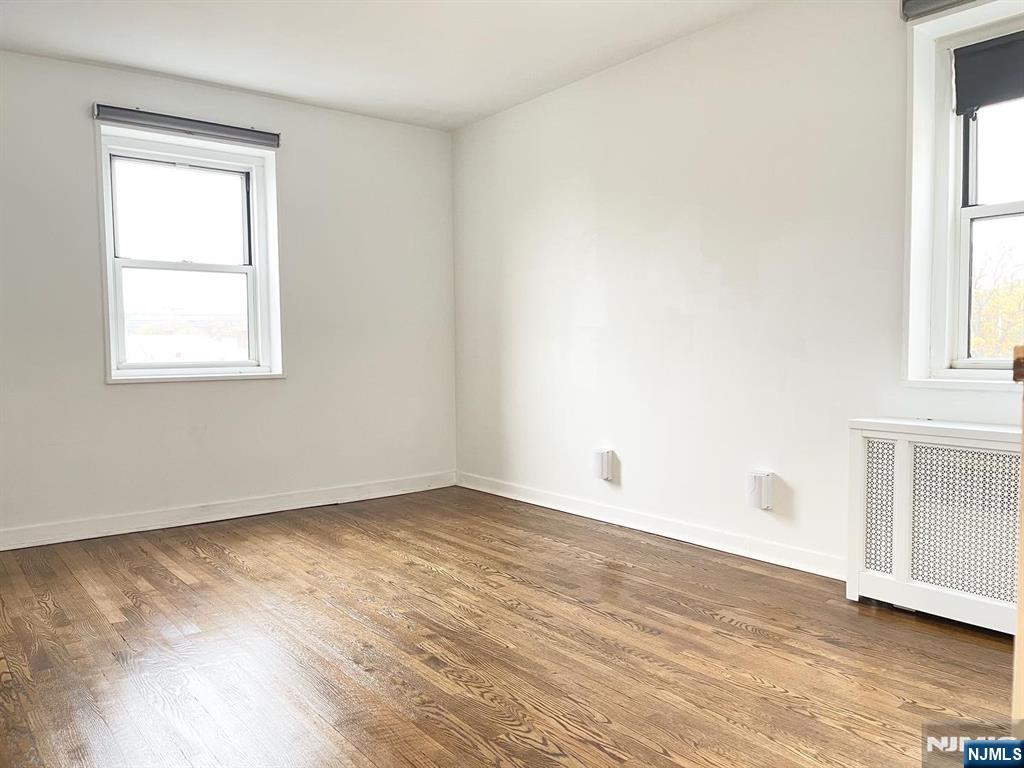 2205 North Central Road, Unit 3D Fort Lee, NJ 07024 - Photo 19 of 29 an empty room with wooden floor and windows
