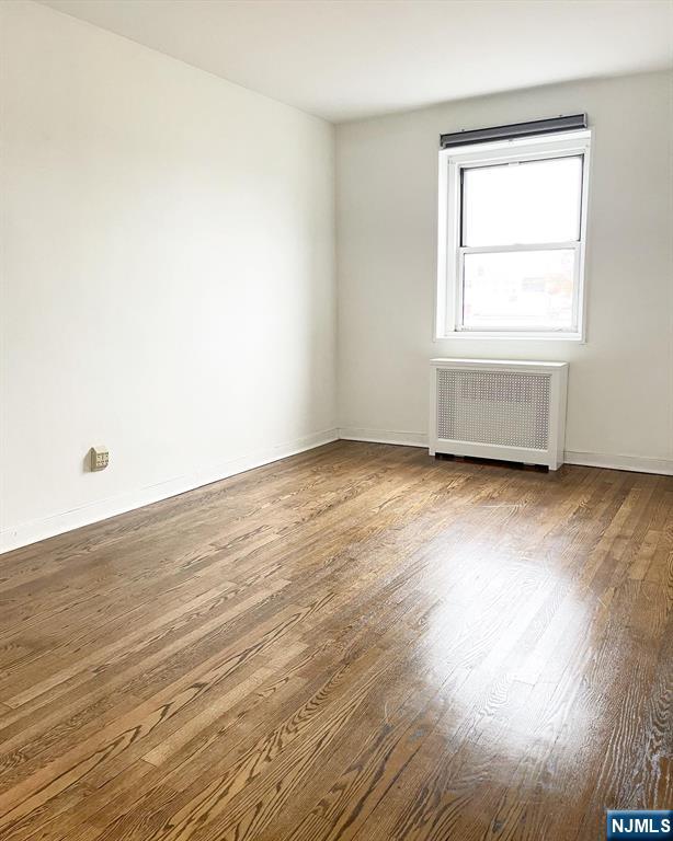 2205 North Central Road, Unit 3D Fort Lee, NJ 07024 - Photo 21 of 29 an empty room with wooden floor and windows