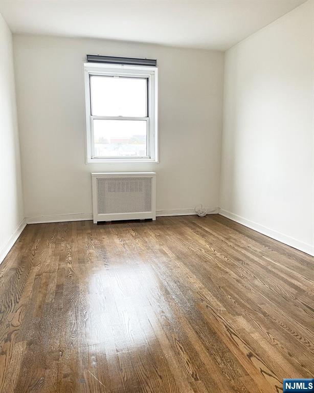 2205 North Central Road, Unit 3D Fort Lee, NJ 07024 - Photo 23 of 29 an empty room with wooden floor and windows