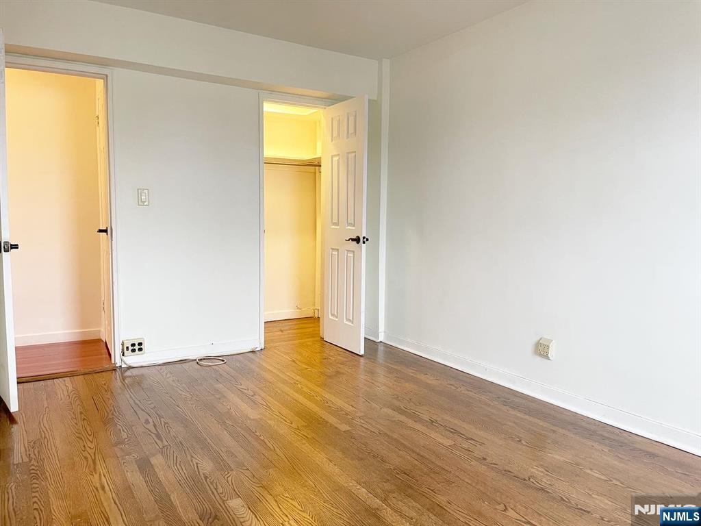 2205 North Central Road, Unit 3D Fort Lee, NJ 07024 - Photo 24 of 29 an empty room with wooden floor and closet