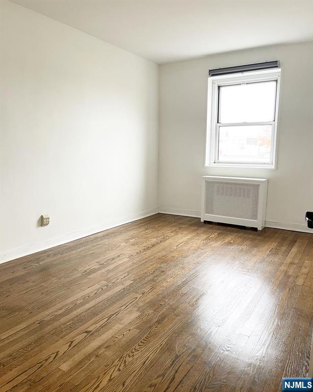 2205 North Central Road, Unit 3D Fort Lee, NJ 07024 - Photo 25 of 29 an empty room with wooden floor and windows