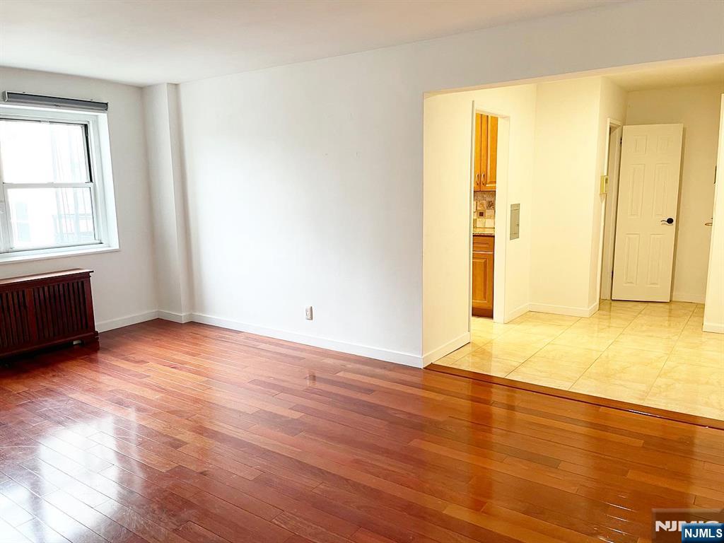 2205 North Central Road, Unit 3D Fort Lee, NJ 07024 - Photo 3 of 29 an empty room with wooden floor and windows