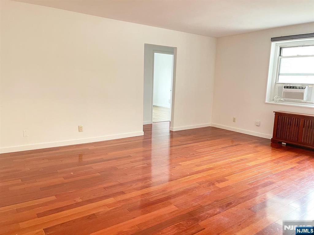 2205 North Central Road, Unit 3D Fort Lee, NJ 07024 - Photo 4 of 29 an empty room with wooden floor and windows