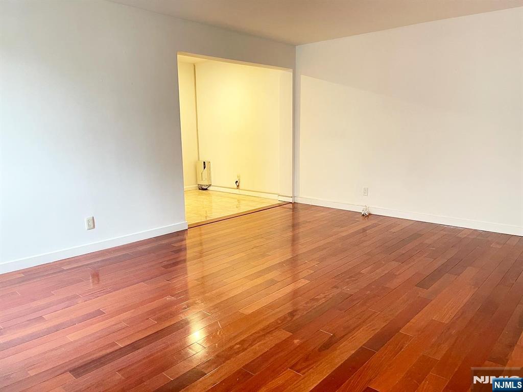 2205 North Central Road, Unit 3D Fort Lee, NJ 07024 - Photo 8 of 29 an empty room with wooden floor and windows