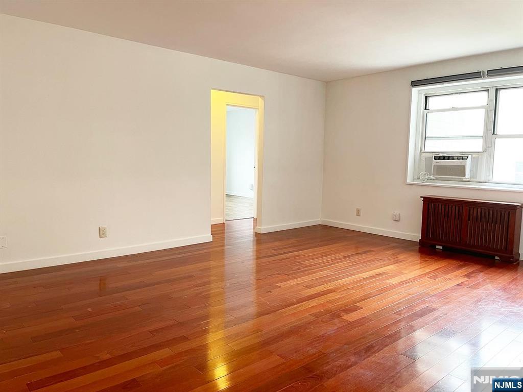 2205 North Central Road, Unit 3D Fort Lee, NJ 07024 - Photo 9 of 29 an empty room with wooden floor and windows