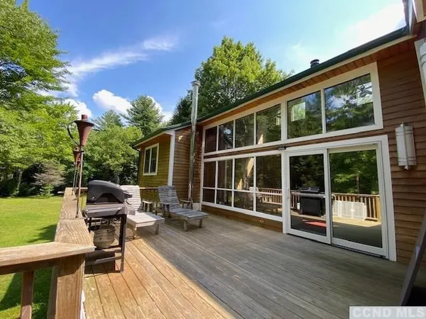 a view of a house with backyard and sitting area