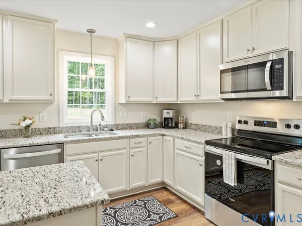 a kitchen with a sink stove and microwave