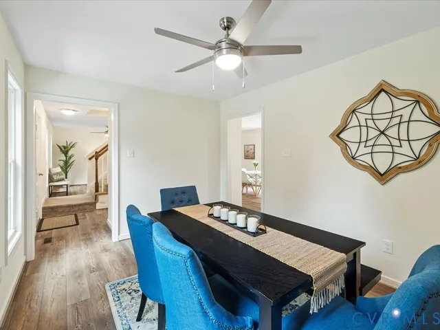 a view of a dining room with furniture and wooden floor