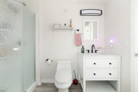 a bathroom with a sink a toilet and shower curtain