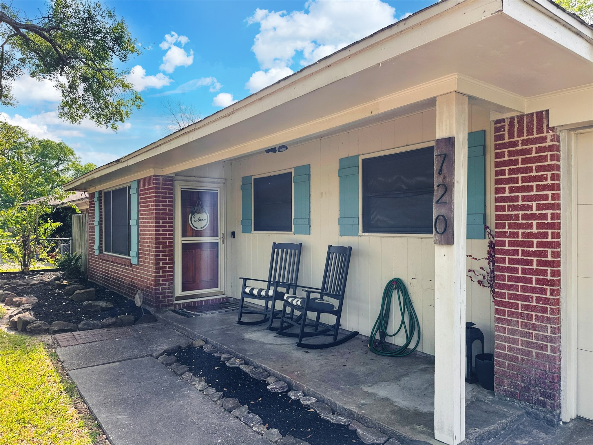 720 Northridge Street Angleton, TX 77515 - Photo 2 of 12 a view of a patio with table and chairs with wooden floor and fence