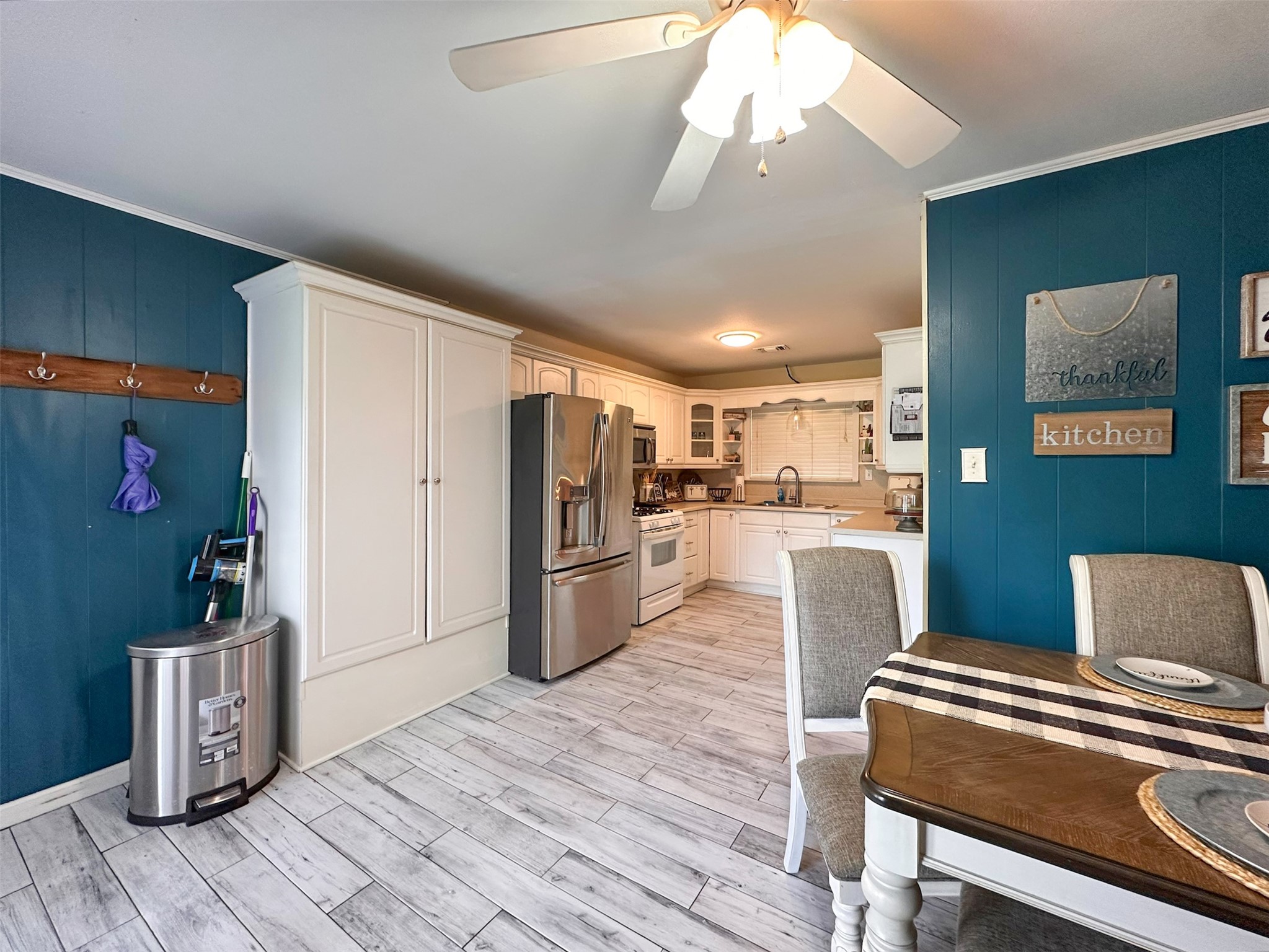 720 Northridge Street Angleton, TX 77515 - Photo 6 of 12 a kitchen with a refrigerator and a stove top oven