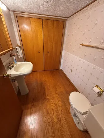 a bathroom with a sink mirror vanity and toilet