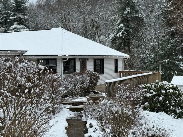 a house with lots of trees in the background