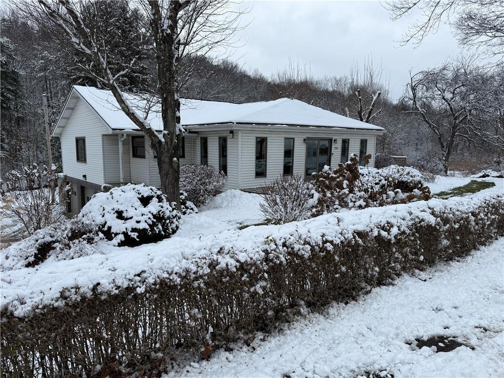 2964 McIntyre Road McIntyre, PA 15756 - Photo 4 of 29 a front view of a house with a yard covered with snow