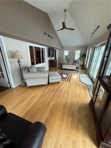 a living room with furniture and a wooden floor