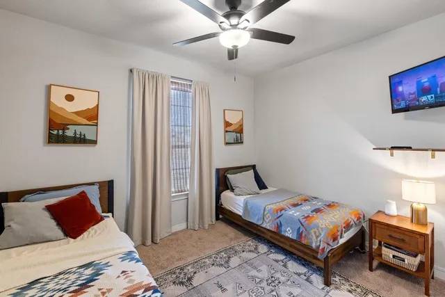 a bedroom with a bed and a chandelier