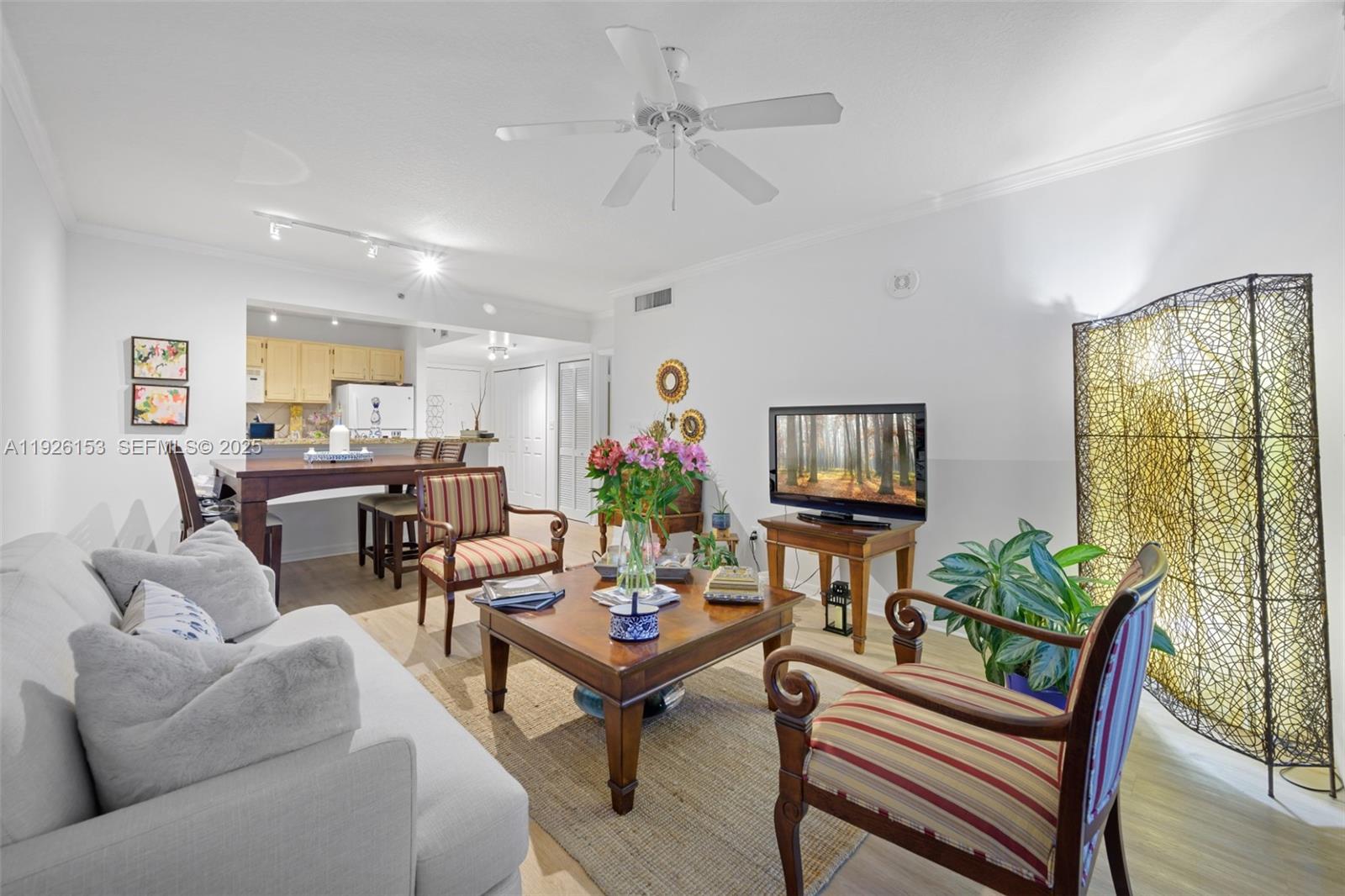 2665 Southwest 37th Avenue, Unit 202 Miami, FL 33133 - Photo 1 of 15 a living room with furniture and a flat screen tv
