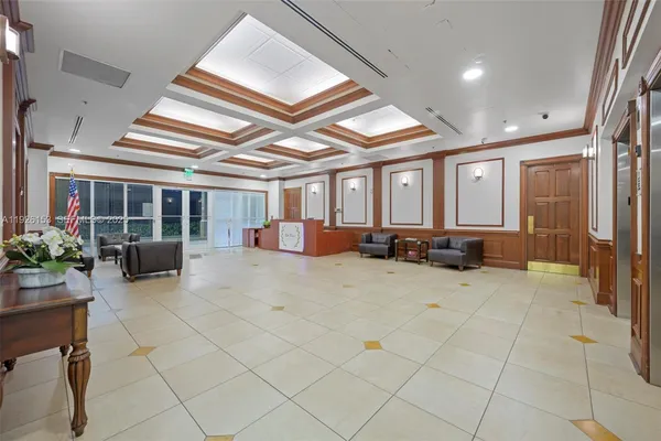 a lobby with furniture and potted plants