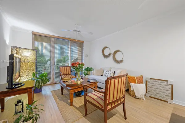 a dining room with furniture and a floor to ceiling window
