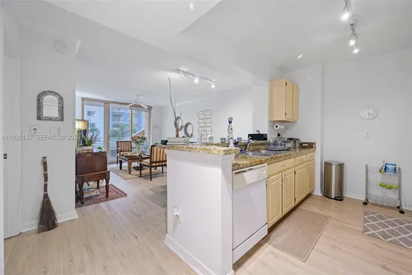a kitchen with sink cabinets and wooden floor