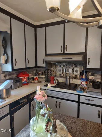 a kitchen with a sink cabinets and wooden floor