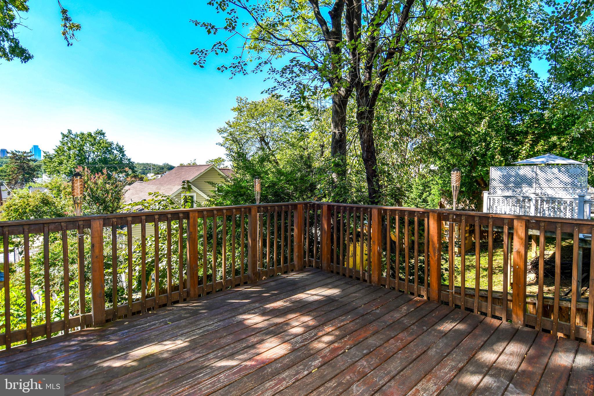 2100 South Quebec Street Arlington, VA 22204 - Photo 18 of 36 a balcony with wooden floor and trees in the back
