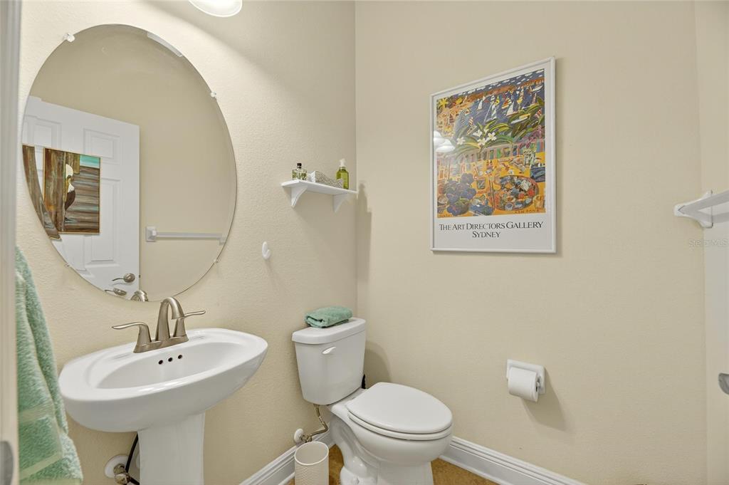 6903 Crestpoint Drive Apollo Beach, FL 33572 - Photo 11 of 95 a bathroom with a toilet a sink and mirror