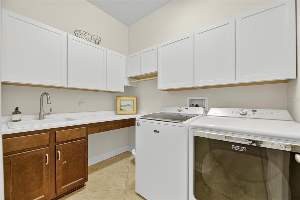 6903 Crestpoint Drive Apollo Beach, FL 33572 - Photo 12 of 95 a utility room with cabinets washer and dryer