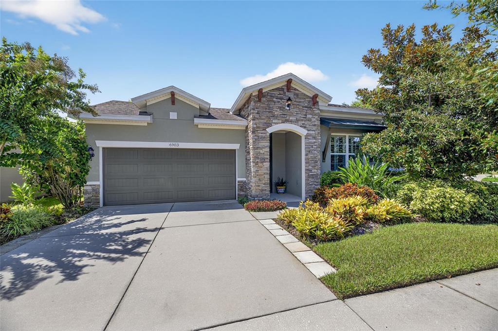 6903 Crestpoint Drive Apollo Beach, FL 33572 - Photo 2 of 95 front view of a house with a yard