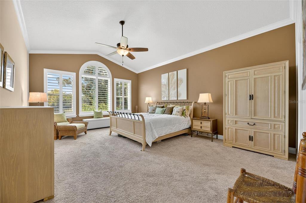 6903 Crestpoint Drive Apollo Beach, FL 33572 - Photo 44 of 95 a bedroom with a bed and a chandelier