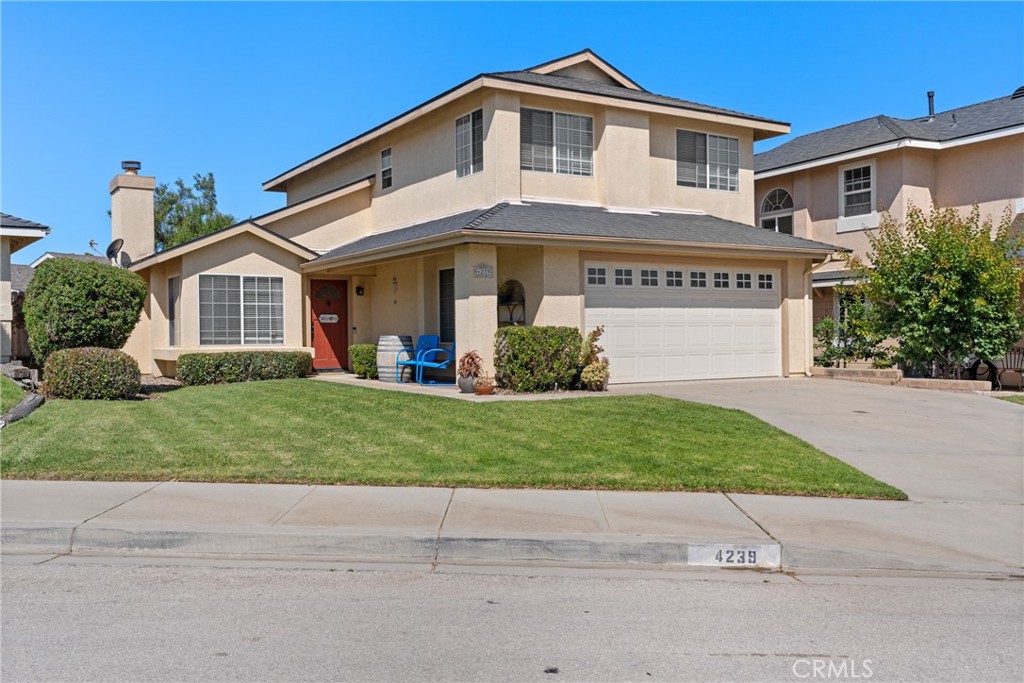 a front view of a house with a garden and plants