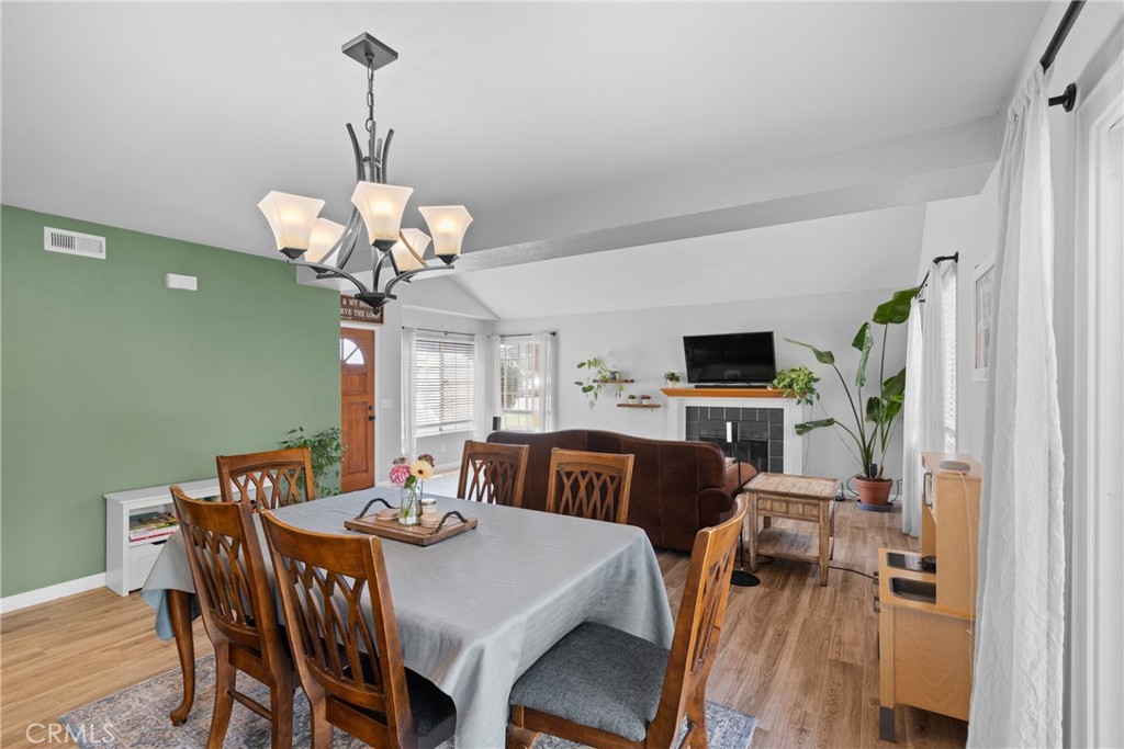 4239 Shadowcrest Drive Santa Maria, CA 93455 - Photo 11 of 33 a view of a dining room with furniture a chandelier and wooden floor