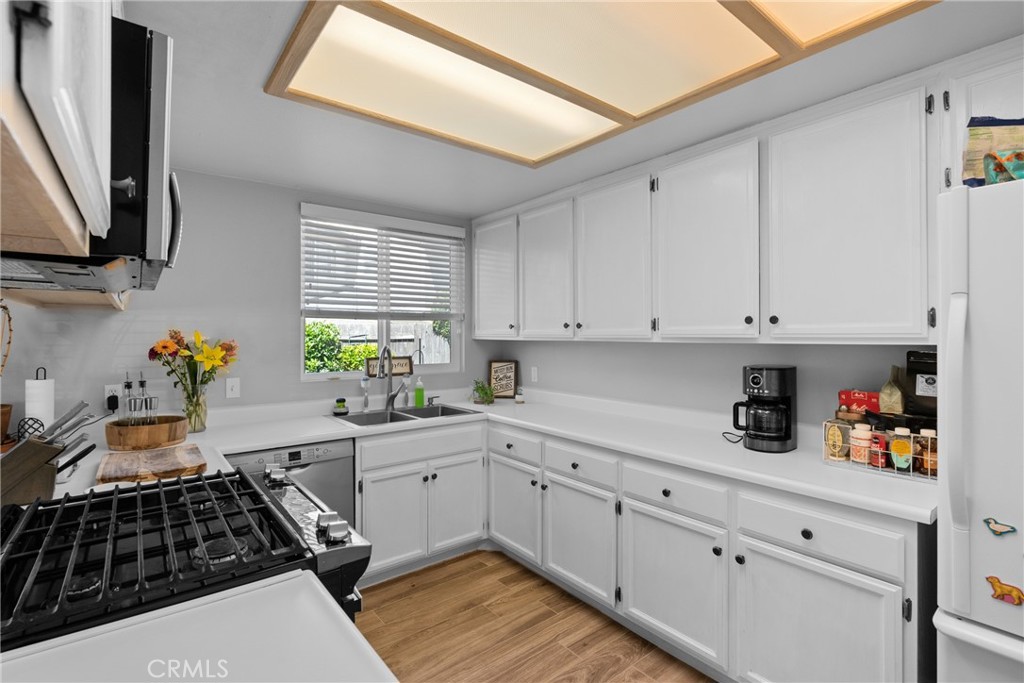 4239 Shadowcrest Drive Santa Maria, CA 93455 - Photo 13 of 33 a kitchen with white cabinets and appliances