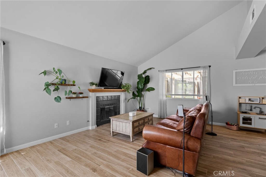4239 Shadowcrest Drive Santa Maria, CA 93455 - Photo 5 of 33 a living room with furniture a fireplace and a flat screen tv