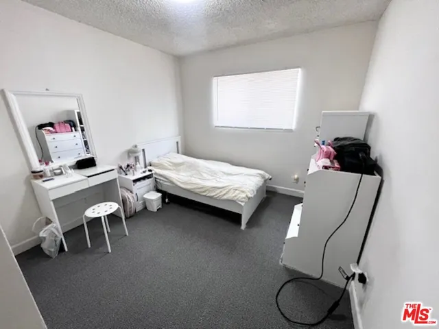 a bedroom with a bed and a chair