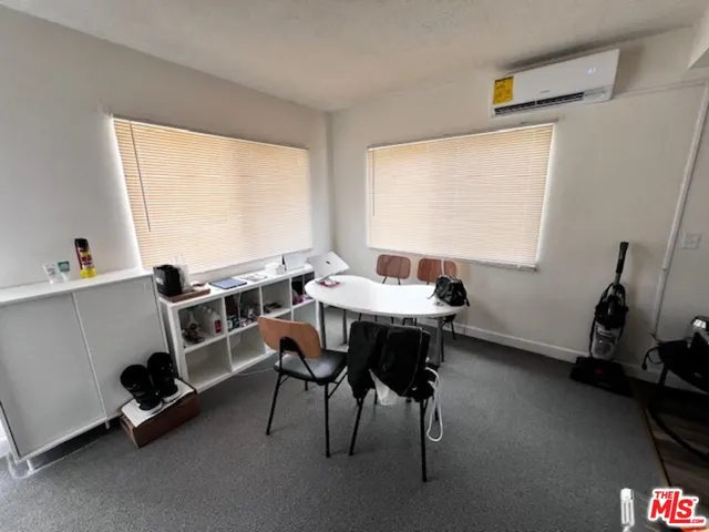 a view of a workspace with furniture and a window