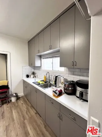a kitchen with cabinets a sink and appliances