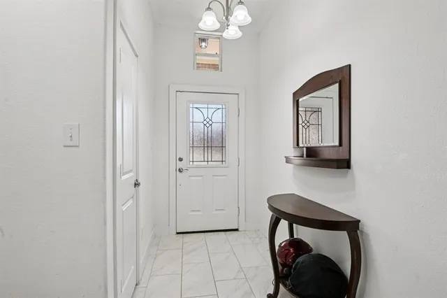 a view of a hallway with entryway wooden floor and cabinet