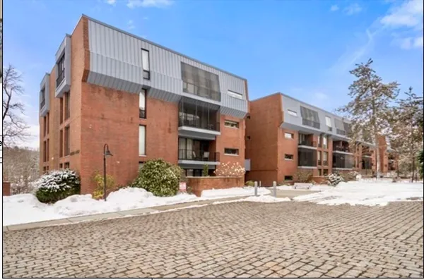 a view of a house with snow on the road