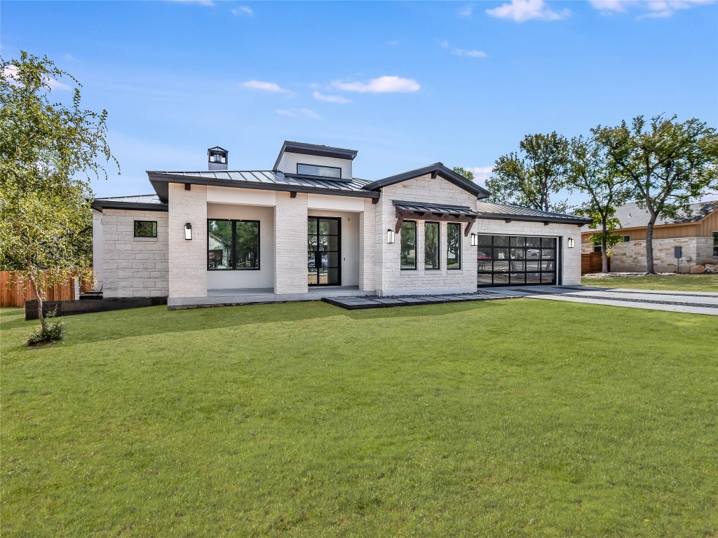 21 Champions Circle Wimberley, TX 78676 - Photo 1 of 27 a front view of house with yard and green space