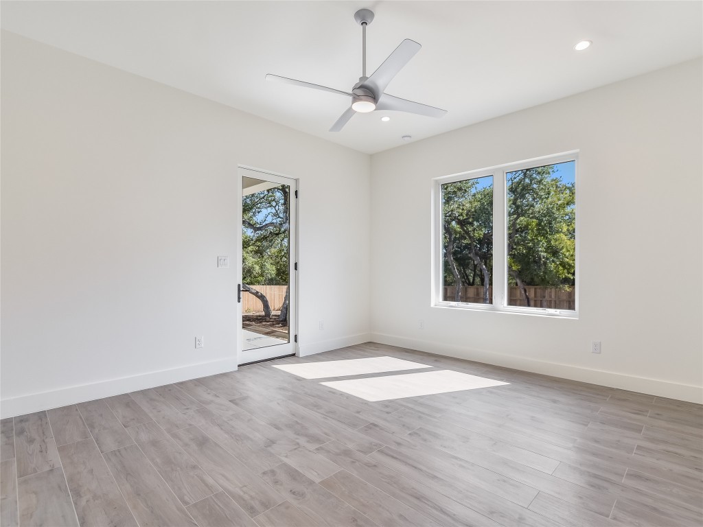 21 Champions Circle Wimberley, TX 78676 - Photo 16 of 27 a view of an empty room with wooden floor and a window