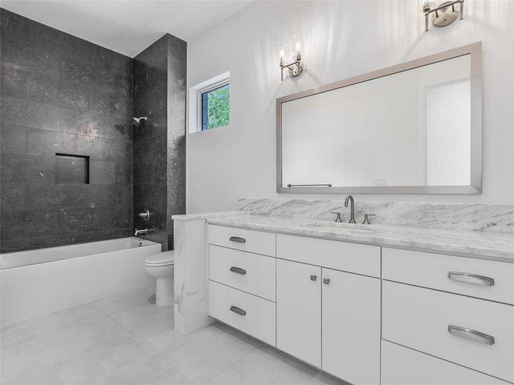 21 Champions Circle Wimberley, TX 78676 - Photo 19 of 27 a bathroom with a sink a toilet and shower