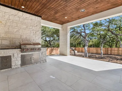 a view of kitchen with stove and refrigerator