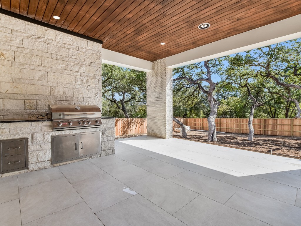 21 Champions Circle Wimberley, TX 78676 - Photo 22 of 27 a open kitchen with a stove and white cabinets