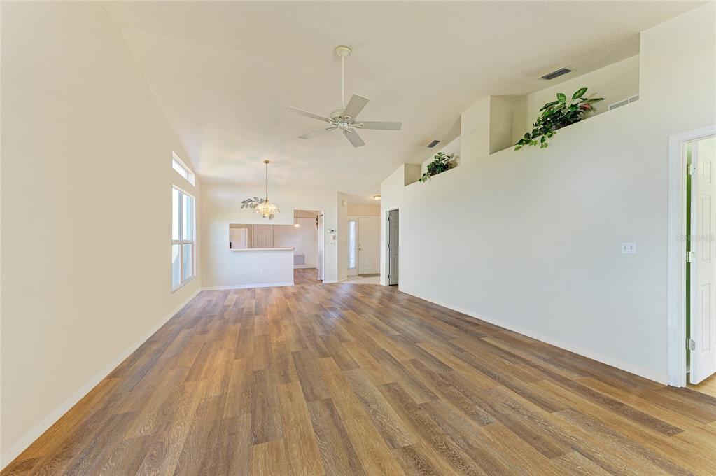 919 Spring Lakes Boulevard Bradenton, FL 34210 - Photo 11 of 43 wooden floor in an empty room with a window