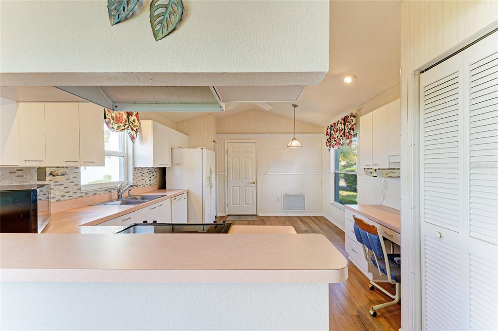 919 Spring Lakes Boulevard Bradenton, FL 34210 - Photo 12 of 43 a view of a kitchen with a sink and a refrigerator